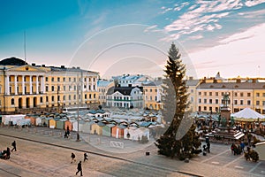 Helsinki, Finland. People Walking On Christmas Xmas Market With Christmas Tree On Senate Square In Background Of