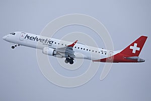 Helvetic Airways plane flying up in the sky