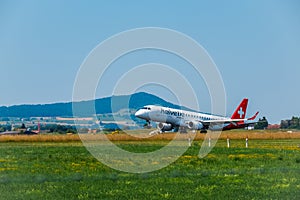 Helvetic Swiss airlines airplane preparing for landing at day time in international airport