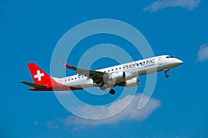 Helvetic Swiss airlines airplane preparing for landing at day time in international airport