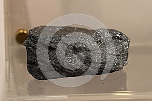 Hematite, Micaceous black collection stone on display selective focus