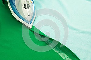 Hemming, shortening green courtain fabric with an adhesive iron-on hemming tape photo