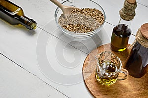 Hemp seed in a glass bowl on the table, Cold pressed oil in a gl