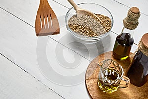 Hemp seed in glass bowl on the table, Cold pressed oil in a glas