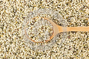 Hemp seeds background with wooden spoon