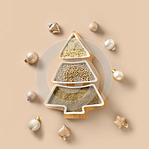 Hemp seeds, flour, kernels in plate shape of Christmas tree. Xmas eco greeting card.