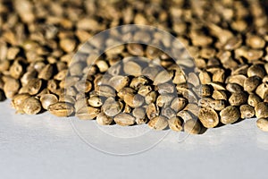 Hemp seeds on white table, copy space image