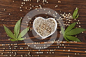 Hemp seeds on wooden background.