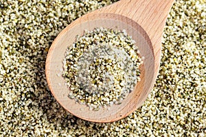 Hemp seeds on a wooden spoon. Alimentary food supplement