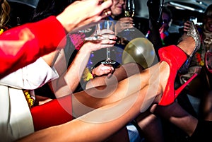 Hen-party in limo with champagne