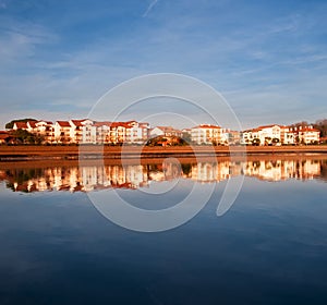 Hendaia is reflected in the water of the beach at sunset