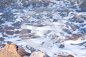 Hendaye France the foam of the waves arriving on the stones