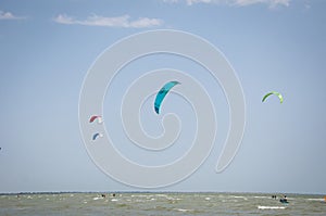 Henichesk, Ukraine - July 12, 2021: Foiling kiteboarding kitesurfing kiteboarder in ocean. Kitesurfing. Seascape with kitesurfer.
