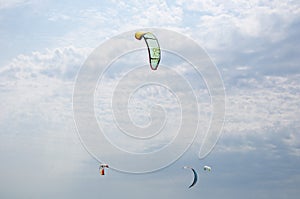 Henichesk, Ukraine - July 12, 2021: Kitesurfing athlete on kite with board. Foiling kiteboarding kitesurfing kiteboarder in ocean