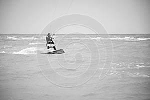 Henichesk, Ukraine - July 12, 2021: Kitesurfing. Extreme sport and watersport in summer. Paragliding and wakeboarding. Man rides a