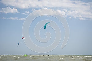 Henichesk, Ukraine - July 12, 2021: Kitesurfing. Practicing kitesurfing at summer beach. Active travel sport recreation.