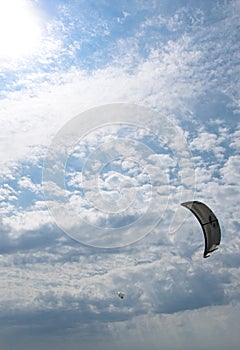 Henichesk, Ukraine - July 12, 2021: Kitesurfing. Practicing kitesurfing at summer beach. Active travel sport recreation.