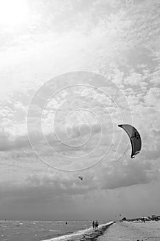 Henichesk, Ukraine - July 12, 2021: Kitesurfing. Practicing kitesurfing at summer beach. Active travel sport recreation.