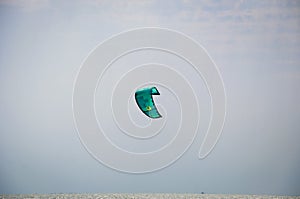 Henichesk, Ukraine - July 12, 2021: Kitesurfing. Practicing kitesurfing at summer beach. Active travel sport recreation.