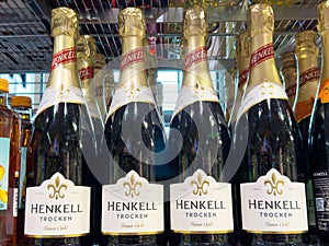 Henkell trocken sparkling wine bottles on shelf with assorted alcoholic beverages