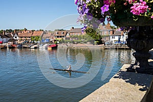 Skyline Of Henley On Thames In Oxfordshire UK With Rower On Rive