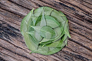 Henna or lawsonia inermis ,green leaves on an old wood background.top view,flat lay