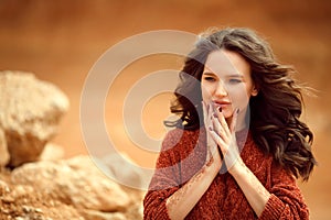 Henna Mehndi. Mehendi on hands. Outdoor portrait of attractive woman in sweater with curly hair