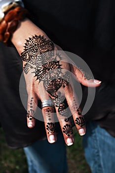 Henna tatto on woman's hand trendy floral design