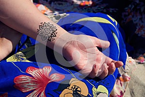 Henna tattoo mehendy on hand mandala photo