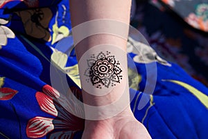 Henna tattoo mehendy on hand mandala photo