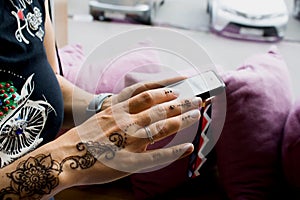 henna tattoo on women hands. Mehndi is traditional Indian decorative art. Close-up, overhead view - beauty and fashion concept