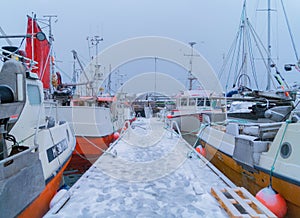 Henningsvaer village in Lofoten islands, Nordland county, Norway, Europe. Ships and boats in marina port in harbor in winter