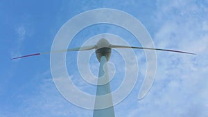 Heolic turbine rotating in the wind, point of view from the base