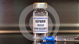 Heparin drug and syringe on black table