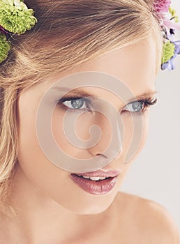 Her beauty is all natural. Studio shot of a beautiful young woman with flowers in her hair.