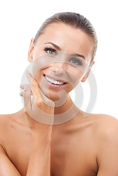 Her beauty treatment worked. Beautiful young woman touching her face while isolated against a white background.