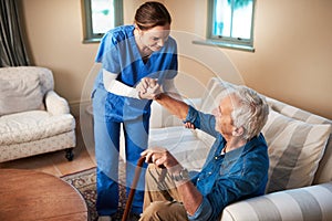 Her caring nature makes her the perfect caregiver. Shot of a caregiver assisting her senior patient at home.