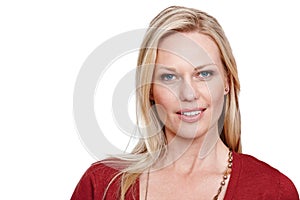 Her confidence shines through. An attractive blonde woman smiling at the camera against a white background.