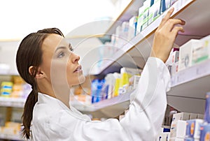 Her experience guarantees the perfect medication. an attractive young pharmacist checking stock in an aisle.