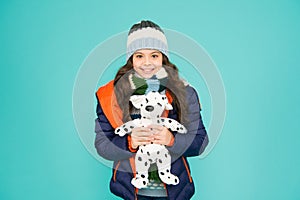 Her favourite toy. Happy child hold soft toy blue background. Little girl smile with toy dog. Kids toy shop or store