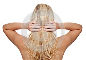 Her hair is her crowning glory. Rearview shot of a young woman with long blonde hair isolated on white.