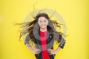 Her hair radiates health.Girl adorable kid long wavy hairstyle. Wind can also damage hair. Protect hair from wind damage