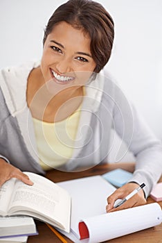 Her hard work will pay off come exam time. Closeup shot of a cute young university student studying for her final exams.