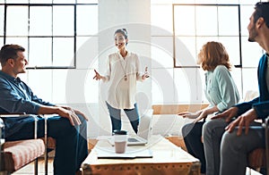 Her ideas are going to change the face of business. a group of young businesspeople having a meeting in a modern office.