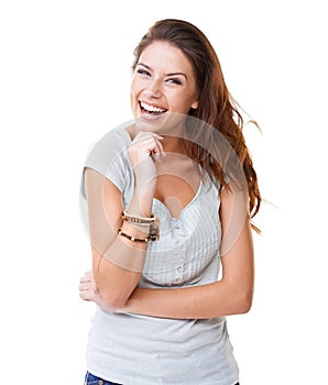 Her laughter is infectious. A pretty young brunette laughing while isolated on a white background.