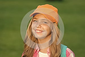 Her new favorite look. Happy kid with beauty look. Fashion look of little hipster. Hip hop girl smile on green grass