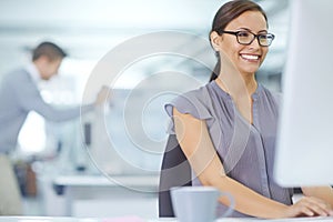 Her office skills are beyond measure. an attractive young office worker sitting at her desk and working on a computer.