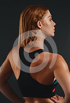 Her perfect form is one to admire. Studio shot of a sporty young woman posing against a black background.