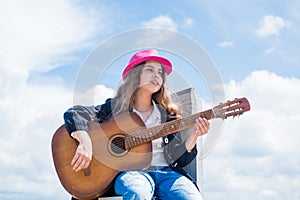 Her perfect style. happy childhood. cute child play guitar outdoor. music and song. vocal school. beautiful teen girl