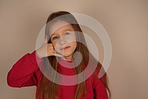 Her playful expression shows she& x27;s fully immersed in the imaginative game. A cute and fun moment of childlike photo